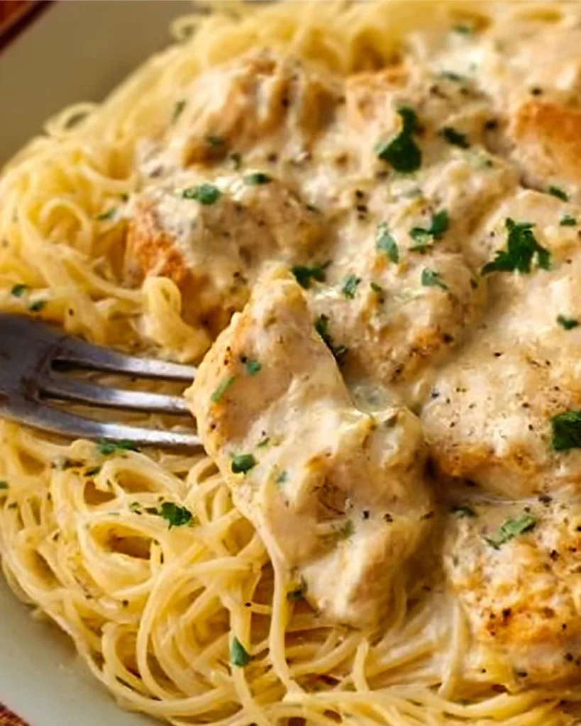 Crock Pot Angel Chicken cooked in a slow cooker with creamy sauce and herbs