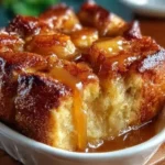 Delicious croissant bread pudding with caramel sauce served in a dish