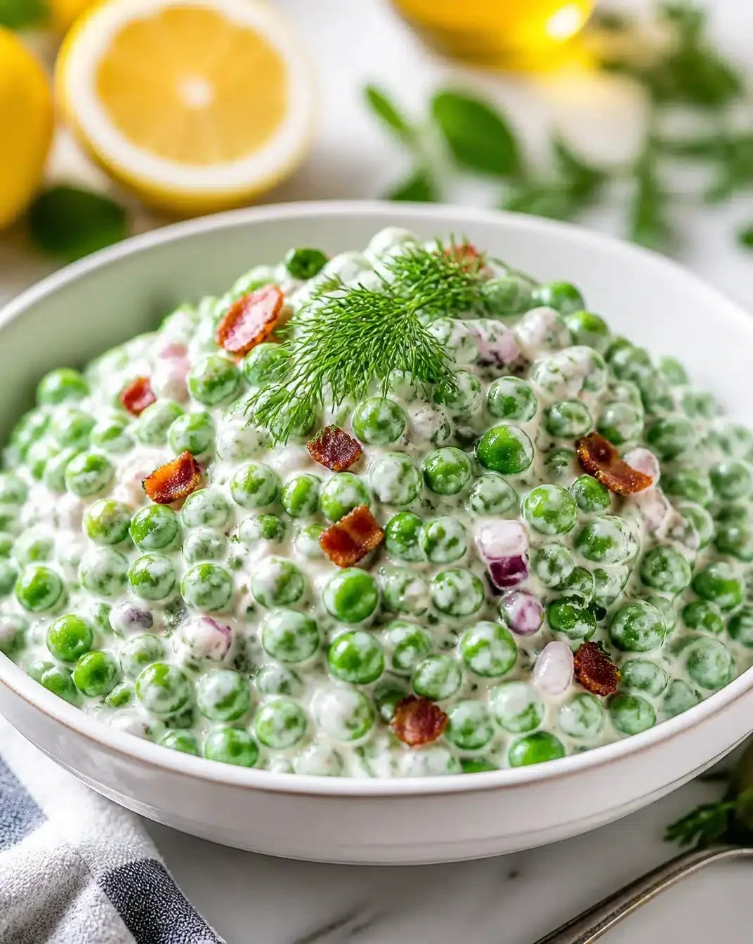 Greek Yogurt and English Pea Salad 1 Greek yogurt and English pea salad in a vibrant bowl, garnished with fresh herbs.