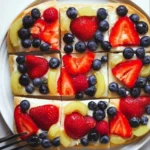 Delicious simple fruit pizza topped with colorful fresh fruits