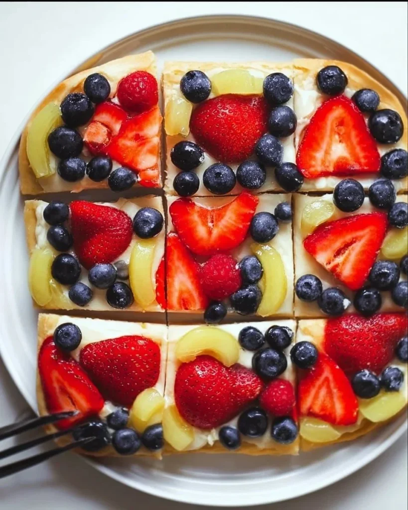 Delicious simple fruit pizza topped with colorful fresh fruits